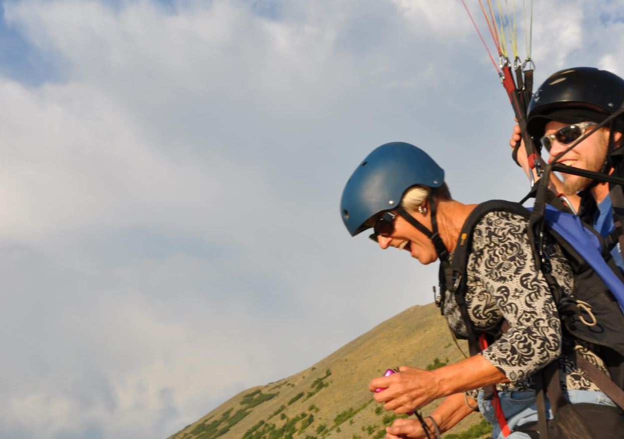 Pilot setting up paraglider for launch